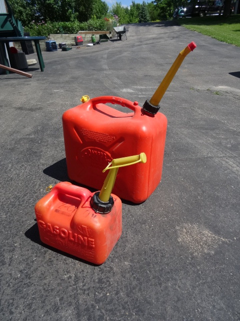 lot 64 image: 5 gal and 1 gal gas can.