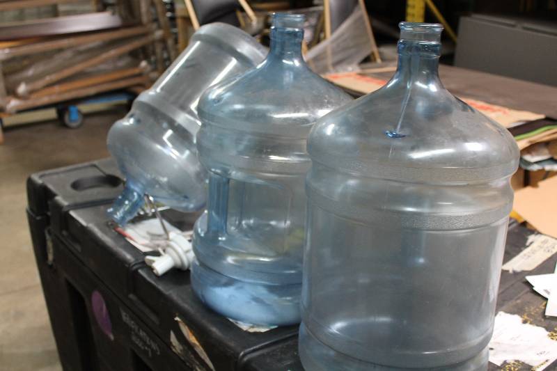 Lot of (5) Including 5 Gallon Poly Carbonate Bottles (3) Metal Stand (1) Plastic Nozzle Spout (1).