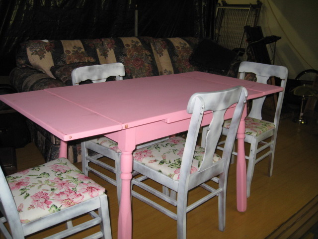 Antique solid wood table with pull out leaves on each end and 4 chairs.