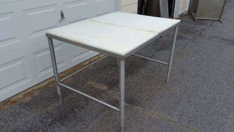 lot 10A image: Meat Cutters Table Fiber Board top.. Approx 5 ft x 36in x 36in h.  Stainless frame