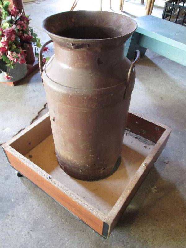Metal milk pail with holes in the b...