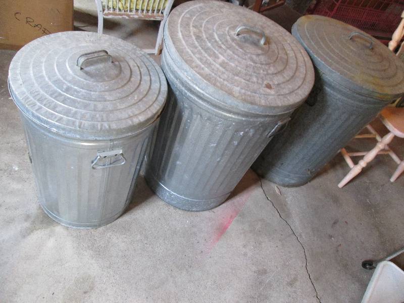 3 metal trash cans with lids...