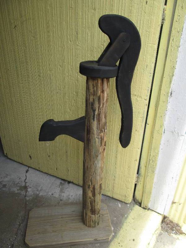 Decorative wood pump plant hanger...