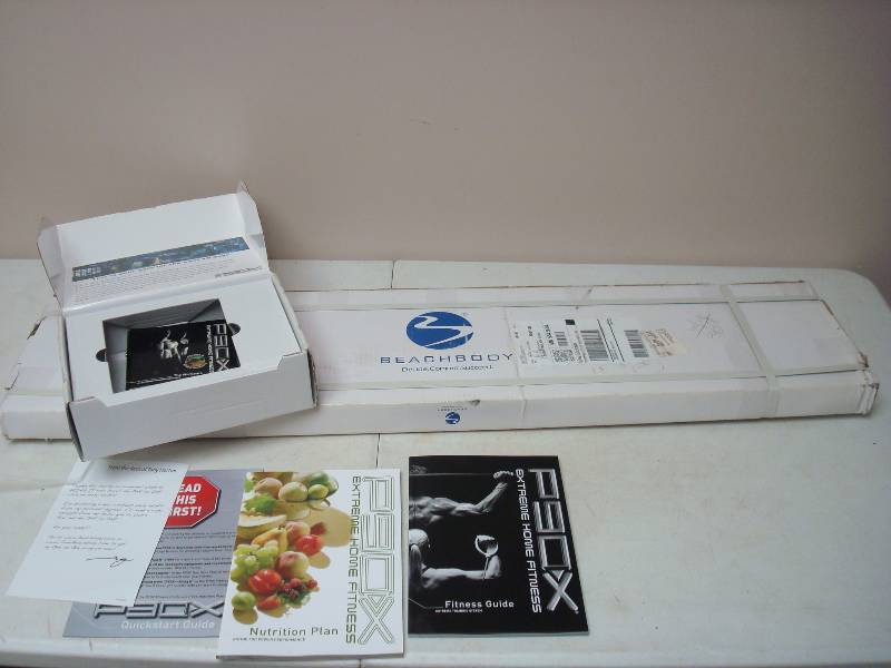 lot 50 image: P90X Beach Body DVD Set And Pull Up Bar,k Unused