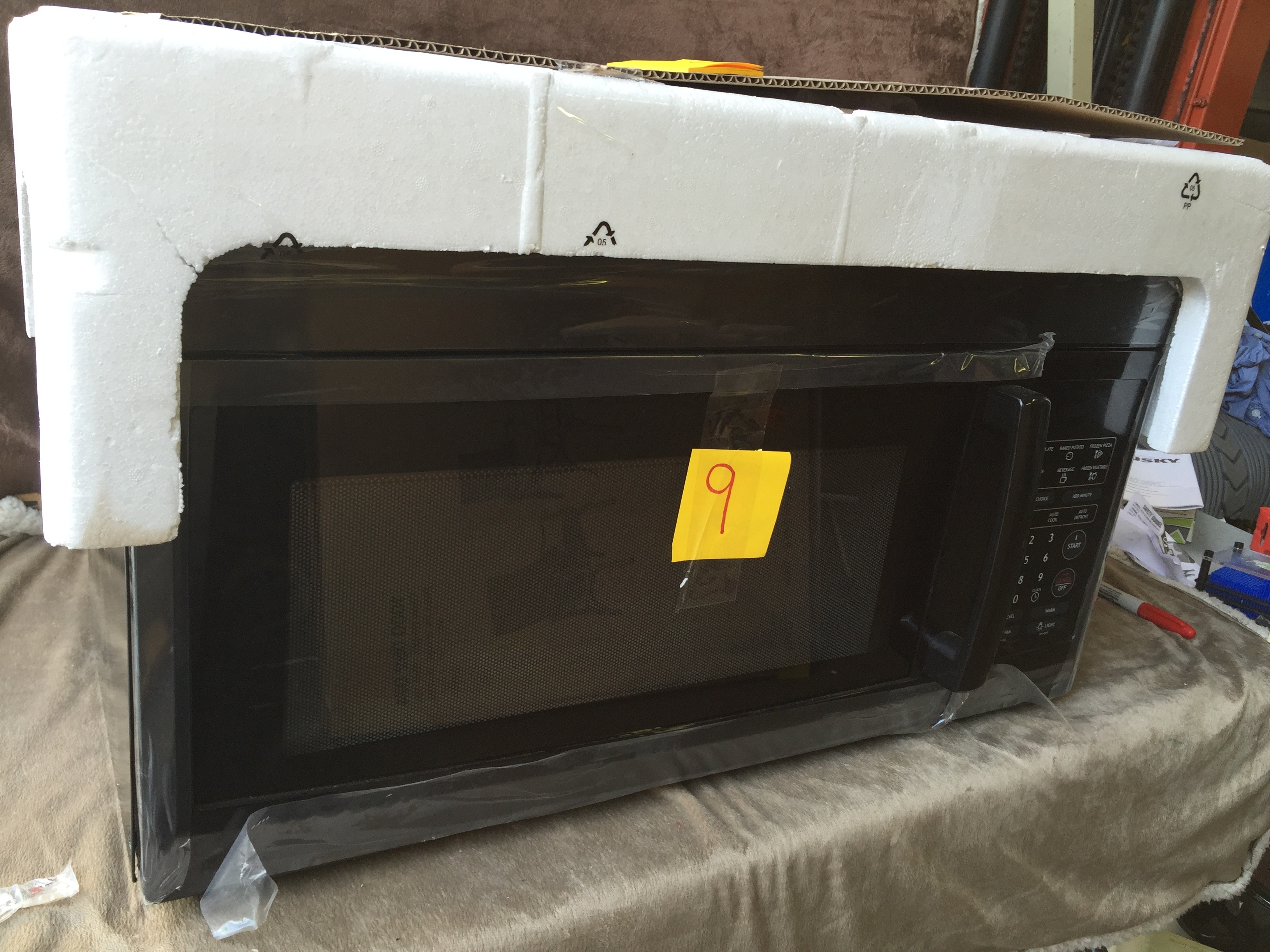 lot 9 image: Magic Chef 1.6 cu. ft. Over-the-Range Microwave in Black