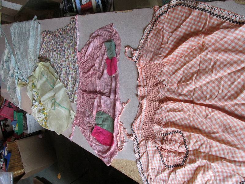 Lot of vintage hand made aprons pot...