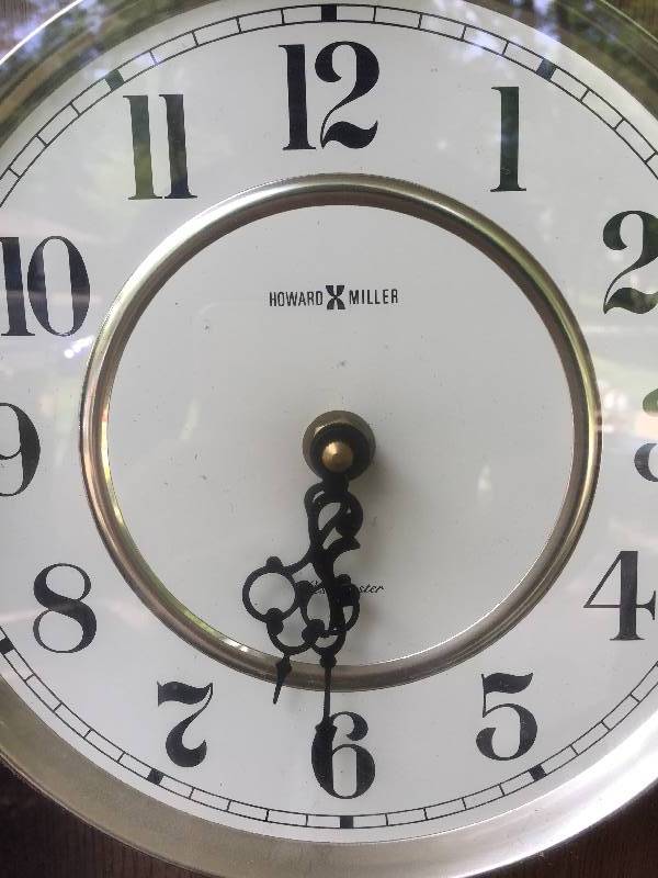 lot 16 image: Howard Miller oak clock Westminster face , pendulum runs is innice condition vintage.