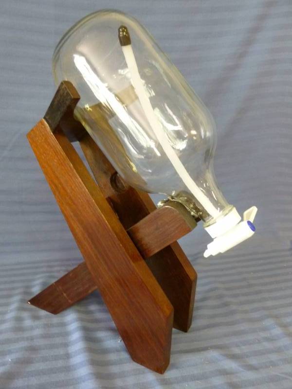 lot 40 image: Glass Bottle With Valve On Wooden Stand