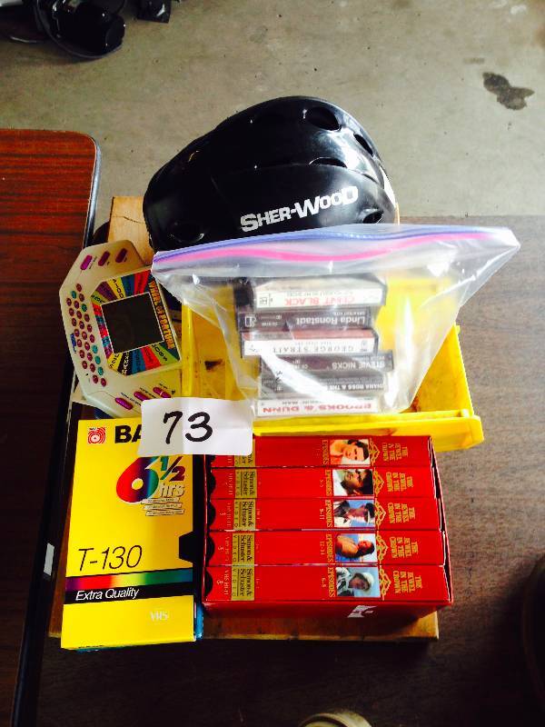 Lot of tapes, games, and hockey helmet
