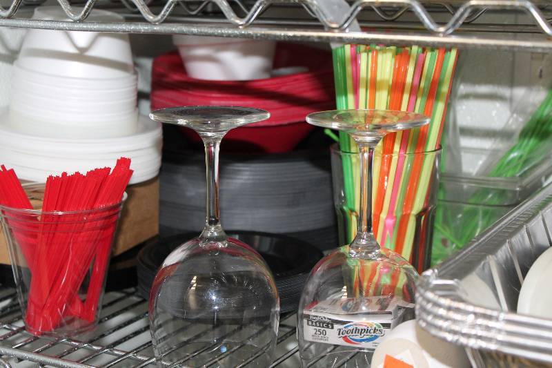 lot 556 image: Shelf Lot Including Wine Glasses Salt & Pepper Shakers Plastic Containers Straws And More.