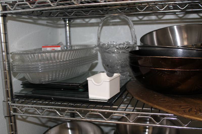 lot 557 image: Shelf Lot Including Stainless Steel Mixing Bowls Plastic Serving Bowls Christmas Lights And More.