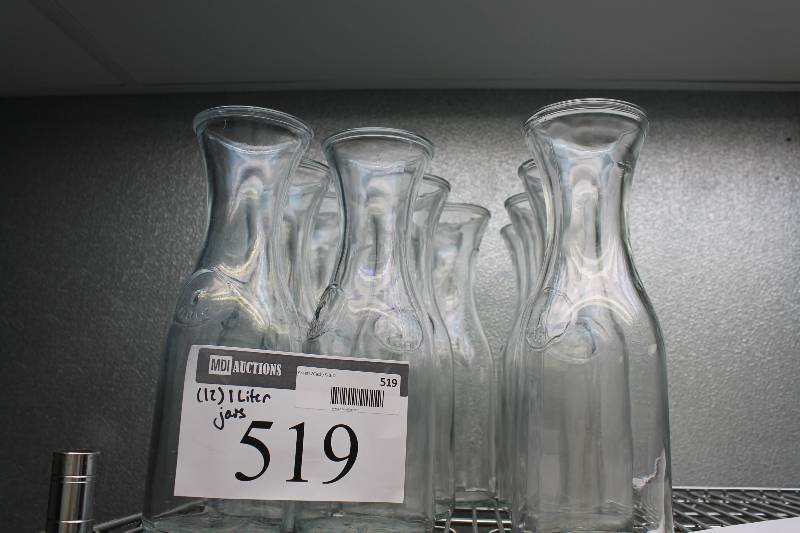 lot 519 image: Lot of (12) Glass Carafes 1 Liter Includes Plastic Container.