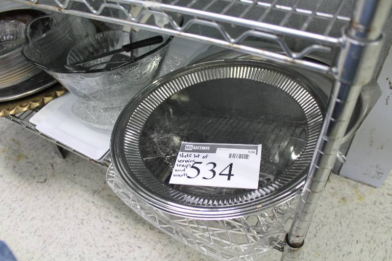 lot 534 image: Shelf Lot Including Plastic Serving Bowls Glass Serving Bowls Metal Serving Trays And More.