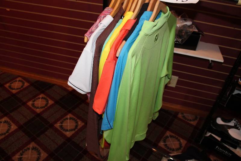 lot 373 image: Clothing Lot Including Golf Polos Vests Womens & Mens Clothing Brands Puma, Under Armor, FJ, And More.