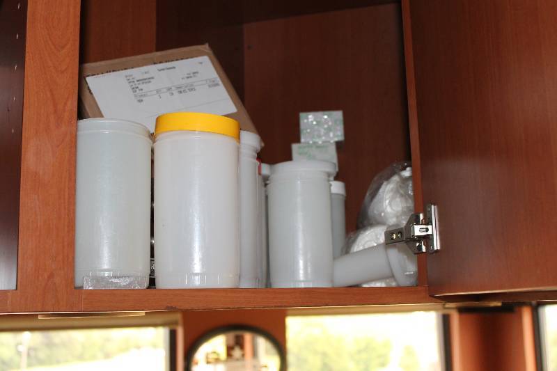 lot 491 image: Cabinet Lot Including Plastic Lids Condiment Bottles wLids Box of Toothpicks And More.