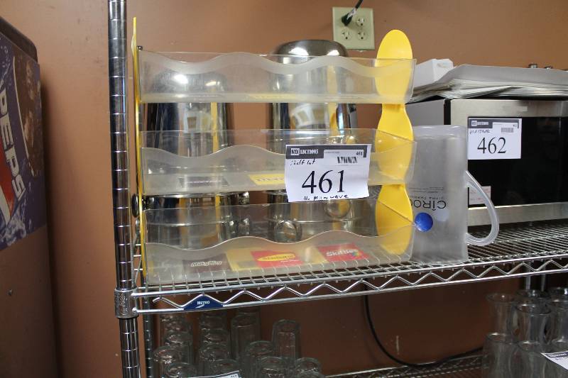 lot 461 image: Shelf Lot Including M & Ms Display Serving Pitchers Does Not Include Microwave.