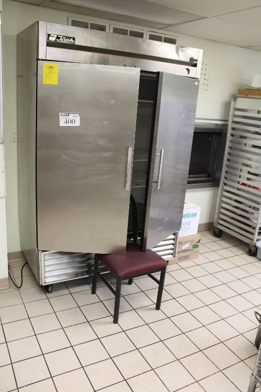 lot 400 image: True Whirlpool Double Door Cooler Refrigerator wInterior Grate Racks & Stainless Steel Exterior Handles & Wheels Gauge 54 x 30 x 83.