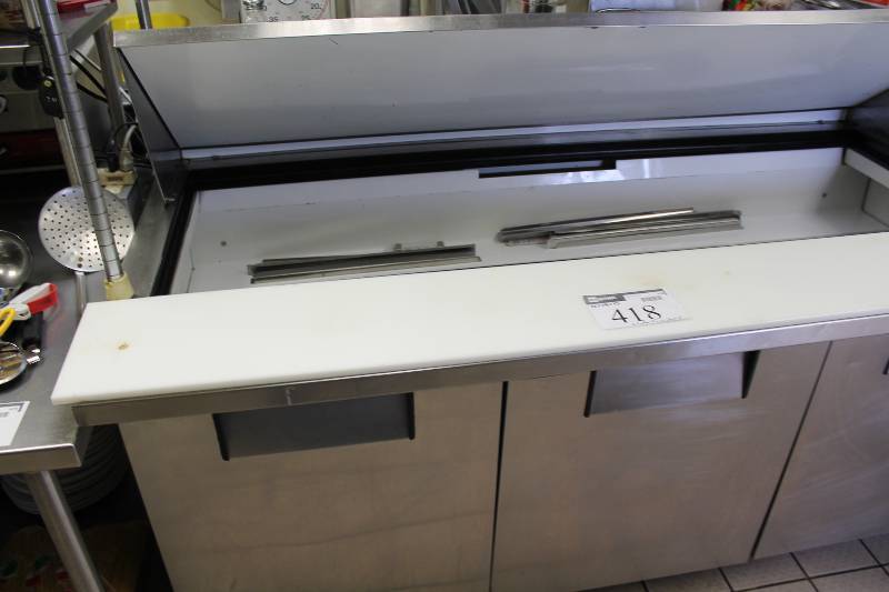 lot 418 image: True Prep Cooler wPrep Table Top & Ingredients Bar wLid 3 Bottom Sections wDoors Wheels Stainless Steel Model TSSU-72-30M-B HP 12 115V Contents Included 72 x 34 x 45.