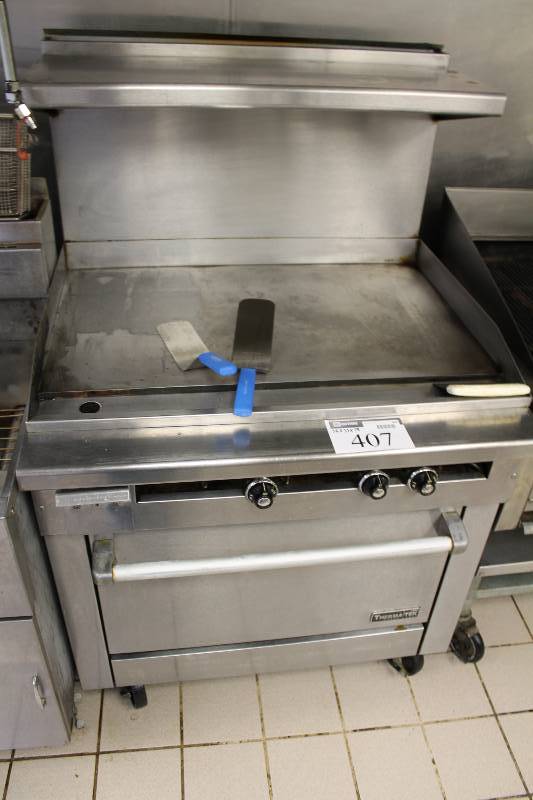 lot 407 image: Thermatek Range Corp. Gas Range wFlat Top Grill Gas Control Knobs Lower Oven wDoor & Handle Includes Grate 36 x 33 x 58.