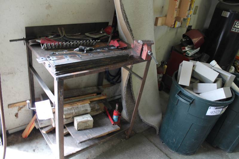 lot 99 image: Metal Work Table wLower Shelf & Vise Grip Attachment Contents Included Jack, Mower Blades And More 24 x 31 x 40.