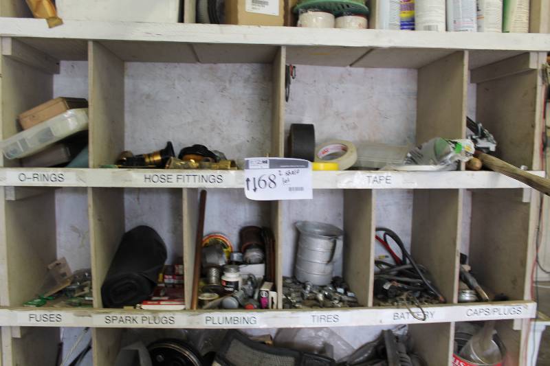 lot 68 image: Shelf Lot of (2) Including Metal Measuring Cup Miscellaneous Plumbing Hardware Roll Of Plastic Trash Bags And More.