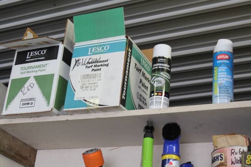 lot 65 image: Shelf Lot Including Spray Paint Cans Plastic Bin Tournament Turf Marking Paint And More.