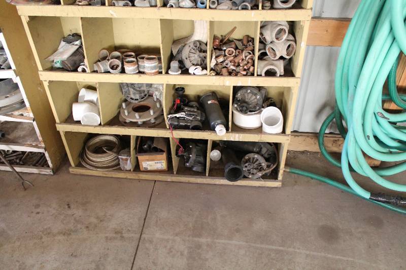 lot 194 image: Contents of Shelf Including PVC Pipe Metal Hardware Fittings & Adapters And More.