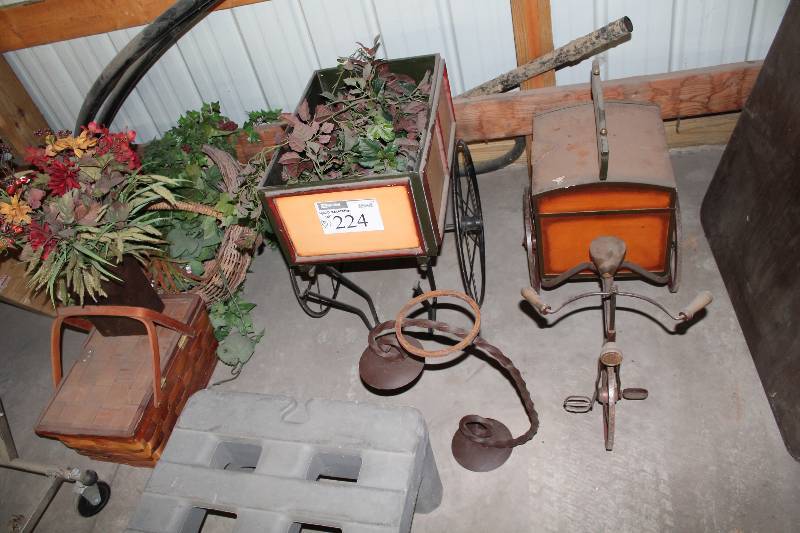 lot 224 image: Lot of (5) Yard Decorations Including Wheel Barrow Wooden Basket, Fake Flowers, And More.