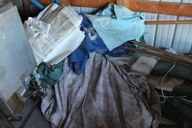 lot 267 image: Floor Lot Including Patio Umbrellas Plastic Tarps And More.