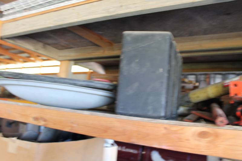 lot 275 image: Shelf Lot of Lawn Mower Parts Including Tires And More.