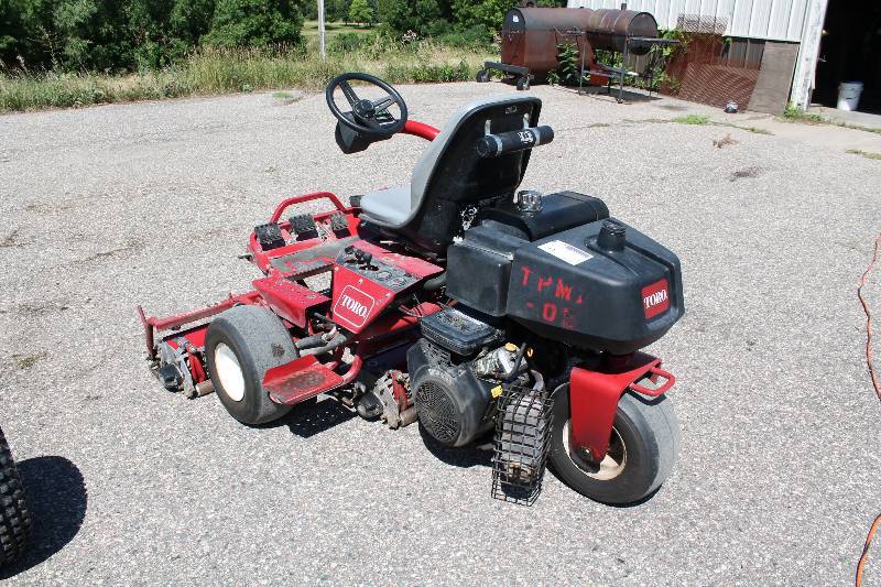 lot 6 image: Toro Greensmaster 3100 Commercial Riding Lawn Mower wSteering Wheel & Seat Front Flood Lights Protective Blade Guards Kohler Engines Motor M16S Tested & Operational.