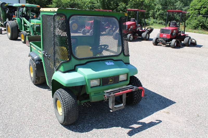 lot 23 image: John Deere Gator 4 x 2 Work Vehicle wTruck Bed & Metal Grate Enclosed Driving Enclosure Removable Tow Bar 2179.9 Hours Tested & Operational - Hard To Get Into Drive.