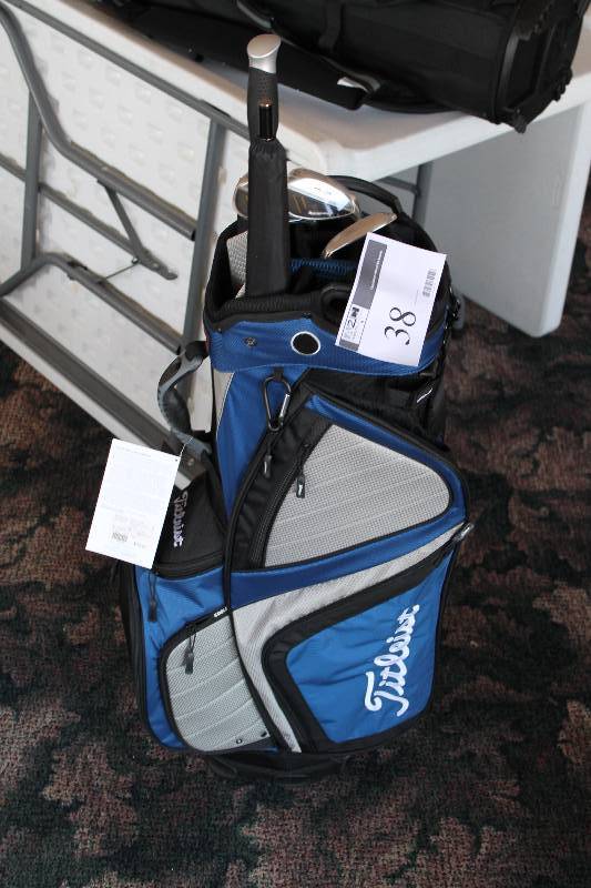 lot 38 image: Golf Lot Including Titleist Golf Bag, BlueWhite Silver Ray Irons And More New Condition.