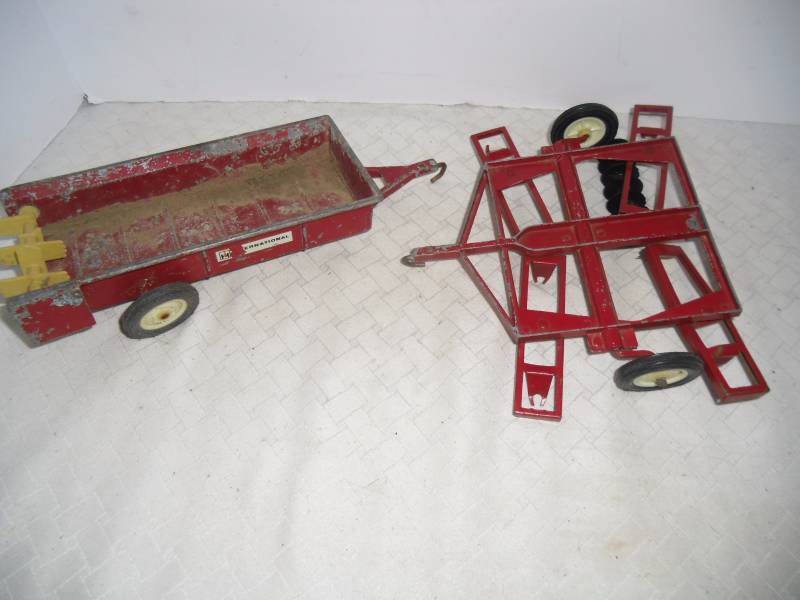 lot 3 image: Cast Iron Tootsie Toys Cars and Ertl Red Farm Equipment pieces