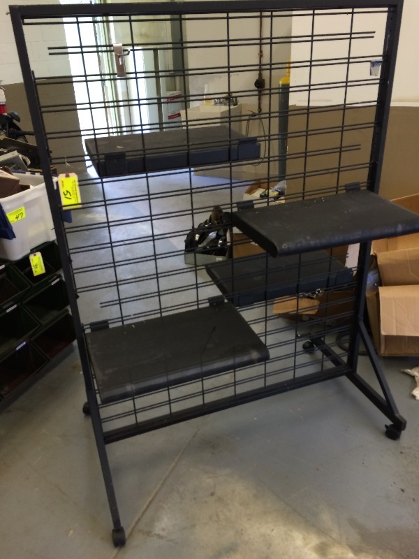 lot 51 image: Display Rack on wheels - adjustable shelves  Measures 50 wide x 68 high   Shelves 23 long x 14 wide