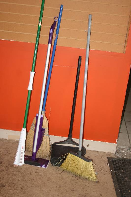 Lot of cleaning supplies- brooms, mop, etc.