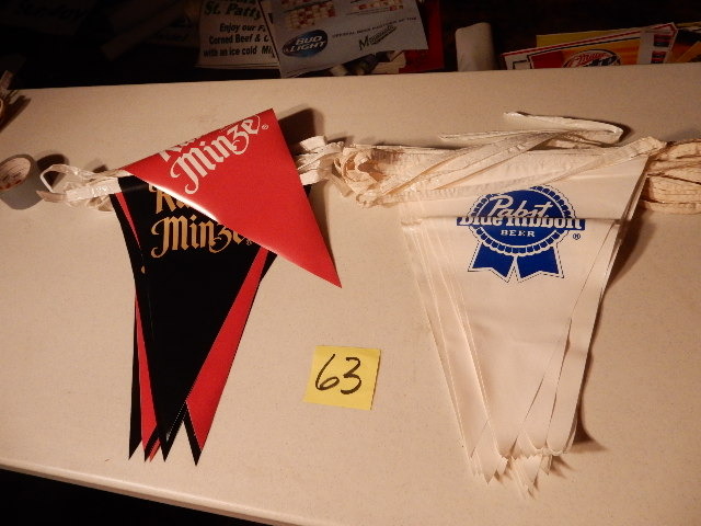 lot 63 image: Pabst Blue Ribbon and RUMPLE MINZE Pennant Strings.. Each approx 20 feet