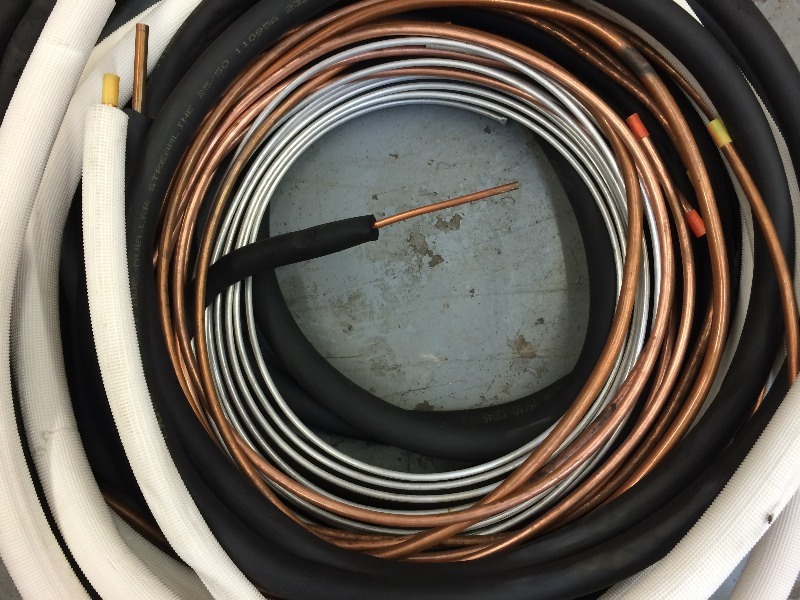 lot 129 image: Assorted copper line sets various sizes and lengths,  rolls of copper and aluminum tubing