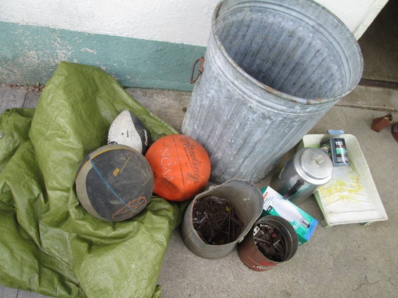 Metal can filled with a tarp, balls...