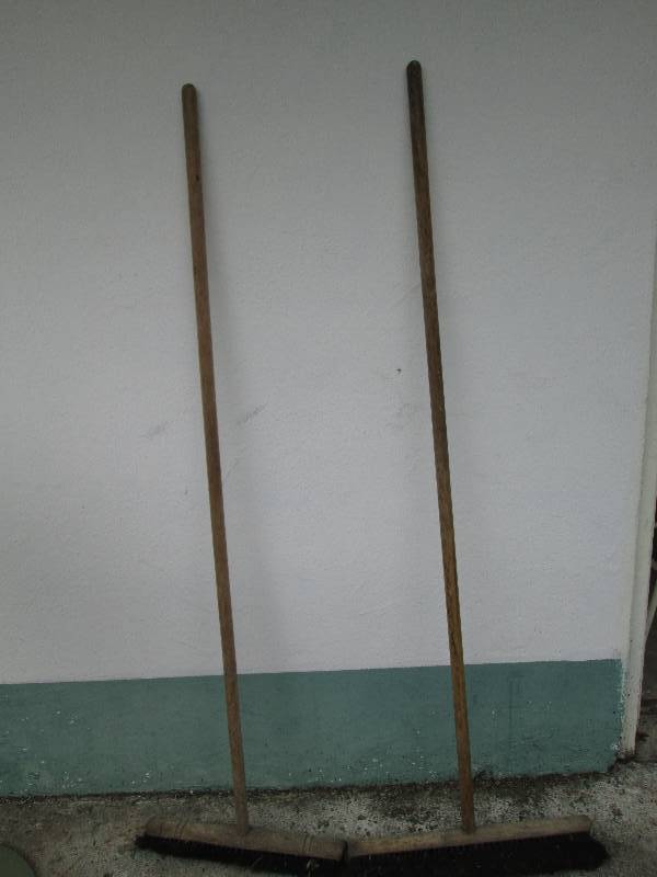 2 Wood handled push brooms...