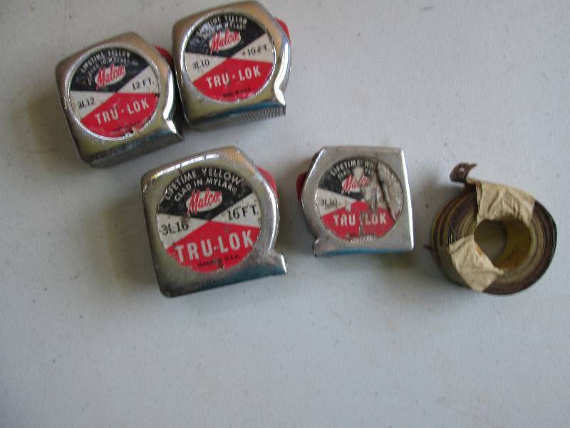 4 vintage tape measures, tape is in...