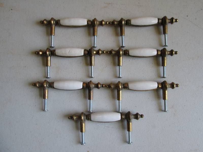 7 brass and ivory door pulls, great...