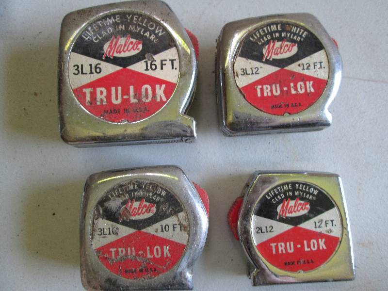 4 vintage tape measures, tape is in...