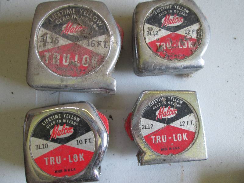 4 vintage tape measures, tape is in...