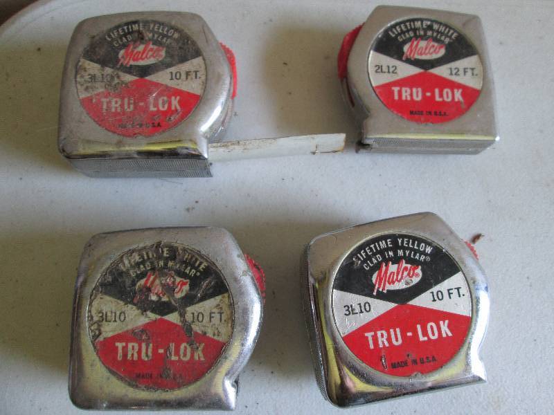 4 vintage tape measures, tape is in...