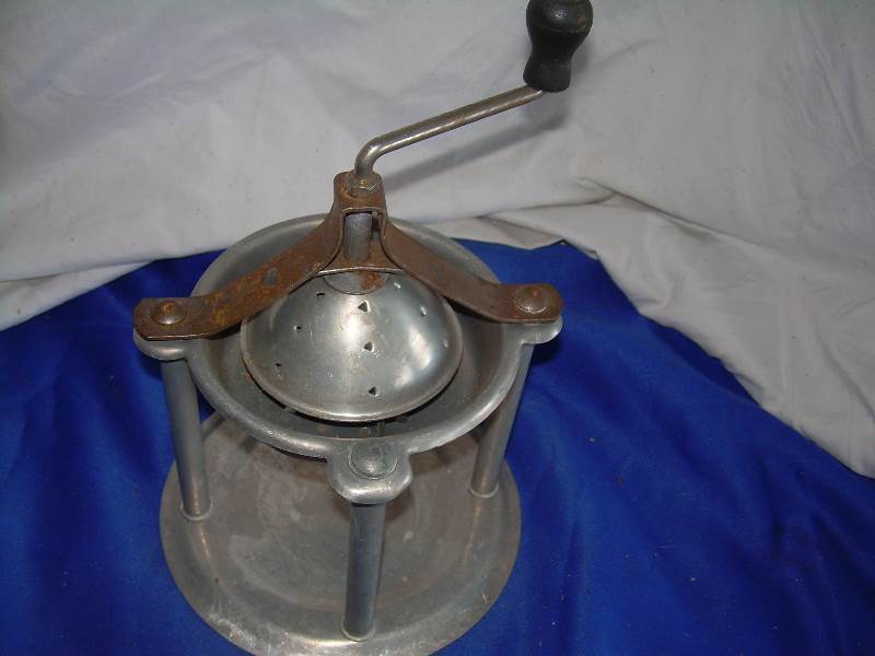 antique food press or juicer