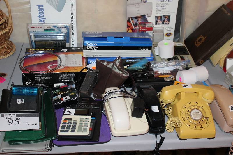 lot 95 image: Table Lot Including Computer Keyboard In Box Telephones wCords& Handset app. 3 ct  Adding Calculator wReciept Printer Tape And More.