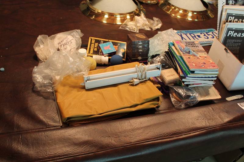 lot 132 image: Table Lot Including Pocket Billiards Tutorials Fluorescent Light wCord Crown Tin Brush In Bag And More.