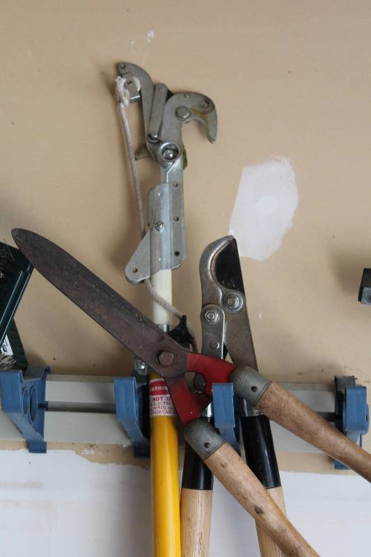 lot 37 image: Wall Lot Including Hedge Trimmers  Gutter Cleaner Branch Cutter And More.