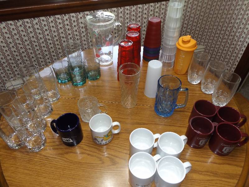 Assortment of glasses and coffee mugs, juice pitcher.